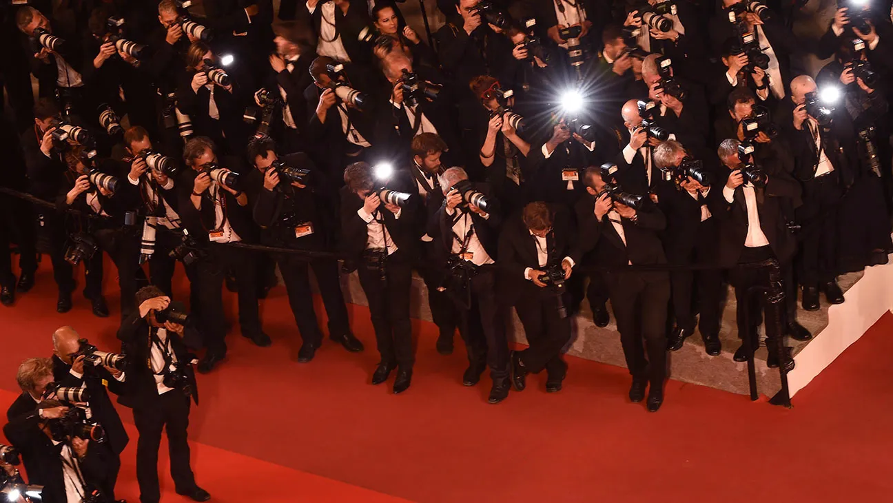 Photographers on the red carpet with camera flashes